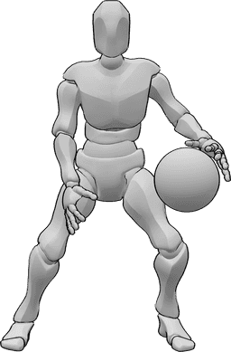 Référence des poses- Dribble à deux mains - L'homme regarde vers l'avant et dribble le ballon de basket à deux mains.
